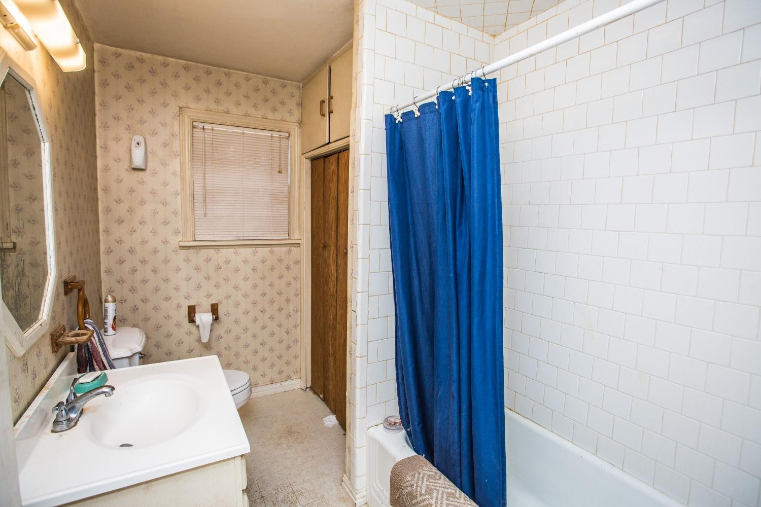 2422 33rd Street Lubbock, TX 79411 - Photo 25 of 35 a bathroom with a sink and a tub