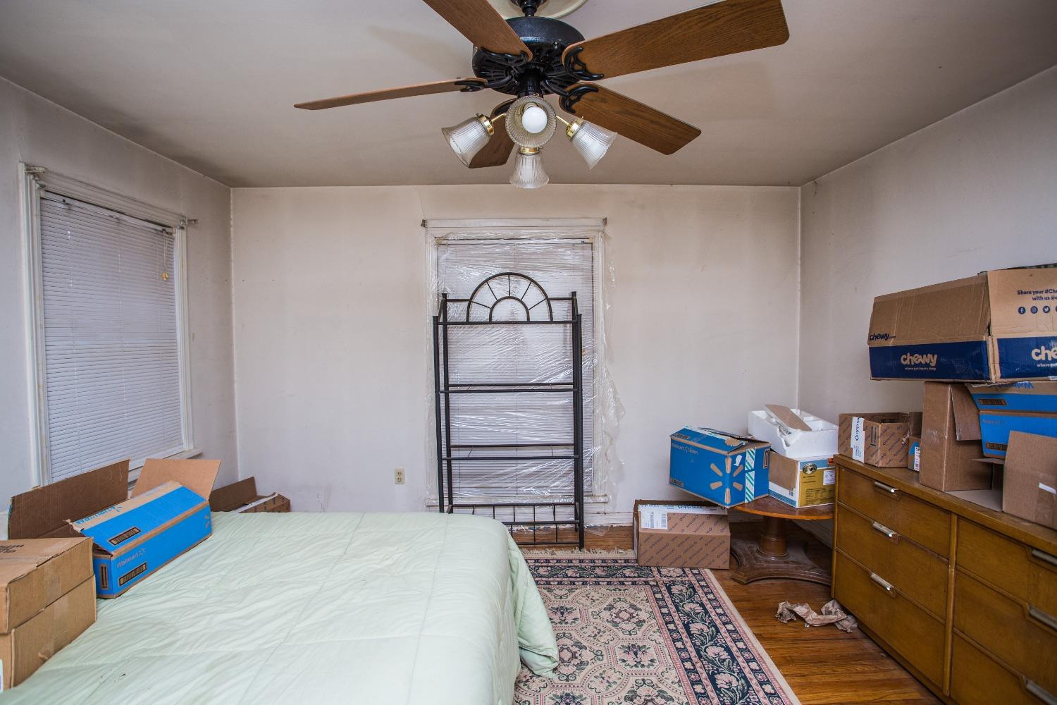 2422 33rd Street Lubbock, TX 79411 - Photo 27 of 35 a bedroom with a bed and a chandelier