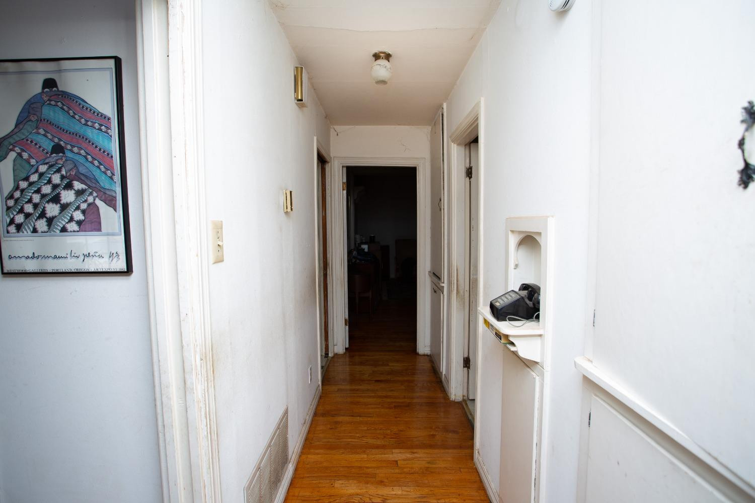 2422 33rd Street Lubbock, TX 79411 - Photo 29 of 35 a view of a hallway with wooden floor and a bathroom