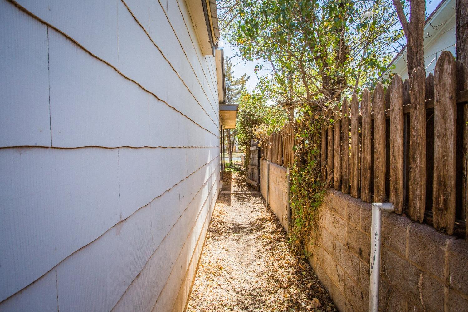 2422 33rd Street Lubbock, TX 79411 - Photo 34 of 35 a view of a pathway of a building with wooden fence