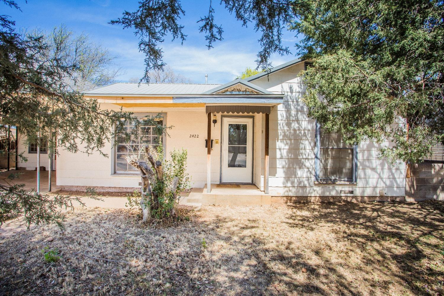 2422 33rd Street Lubbock, TX 79411 - Photo 9 of 35 a view of a house with backyard and tree