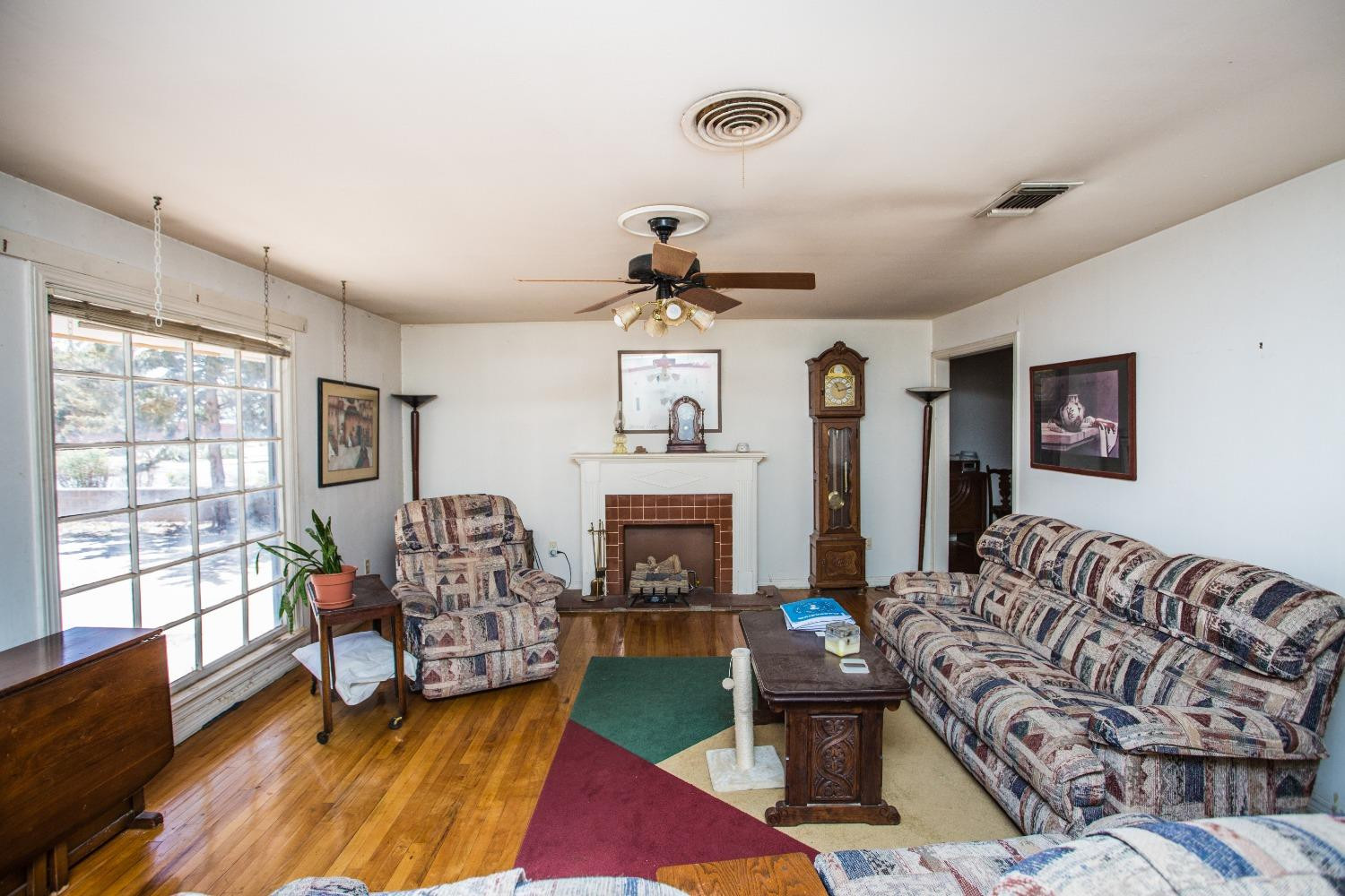 2422 33rd Street Lubbock, TX 79411 - Photo 10 of 35 a living room with furniture and a fireplace