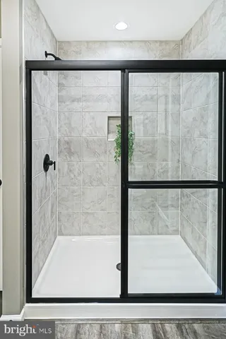 a bathroom with a glass shower door