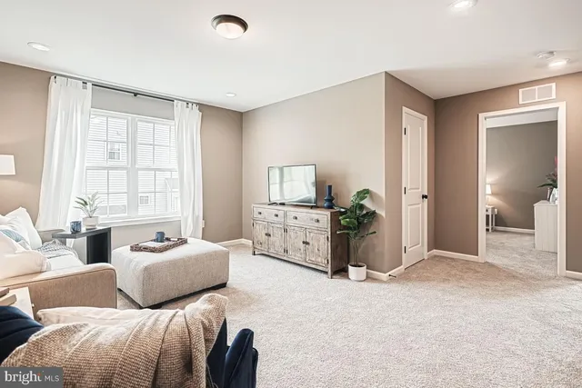 a bedroom with furniture and a large window