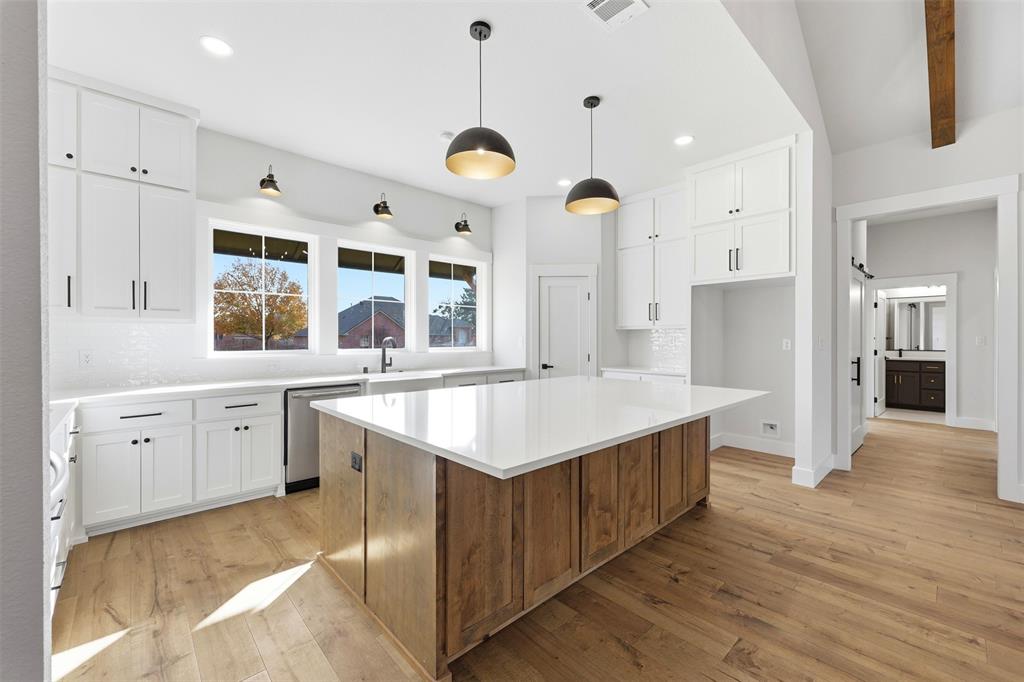509 Emma Lane Grandview, TX 76050 - Photo 14 of 35 a large kitchen with cabinets a sink and stainless steel appliances