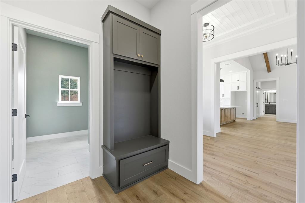 509 Emma Lane Grandview, TX 76050 - Photo 19 of 36 a view of a hallway with wooden floor and staircase