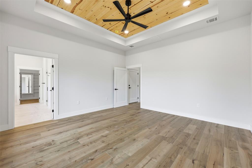 509 Emma Lane Grandview, TX 76050 - Photo 20 of 35 a view of a room with wooden floor and white walls
