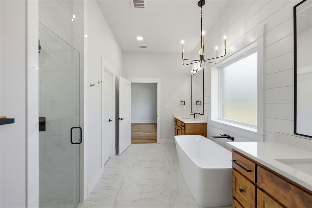 509 Emma Lane Grandview, TX 76050 - Photo 21 of 35 a spacious bathroom with a double vanity sink mirror and shower