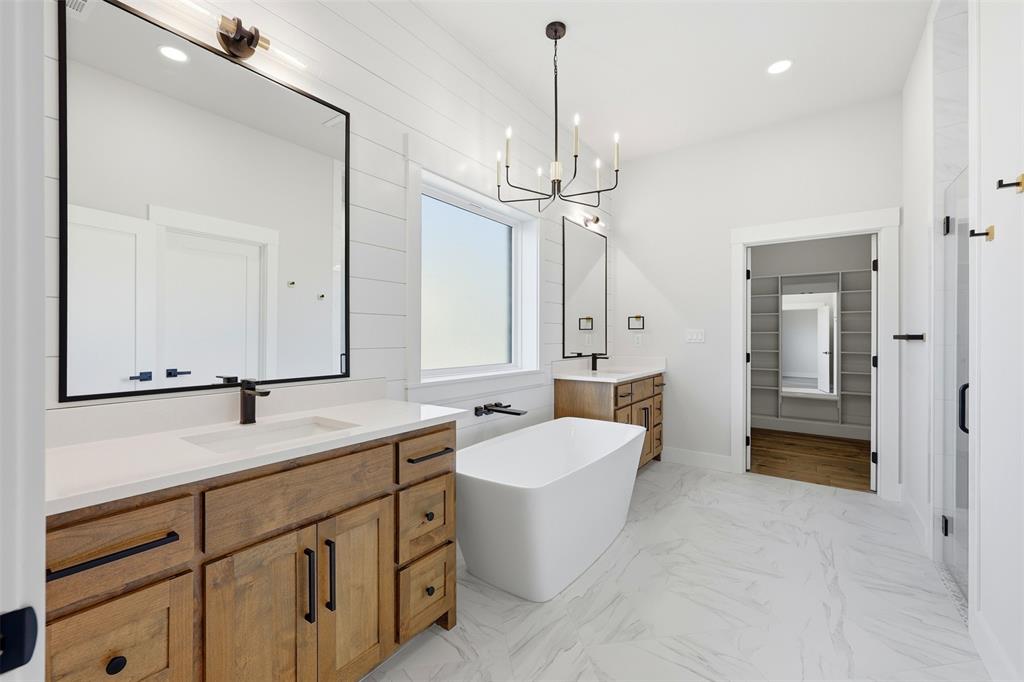 509 Emma Lane Grandview, TX 76050 - Photo 23 of 36 a spacious bathroom with a double vanity sink mirror and bathtub