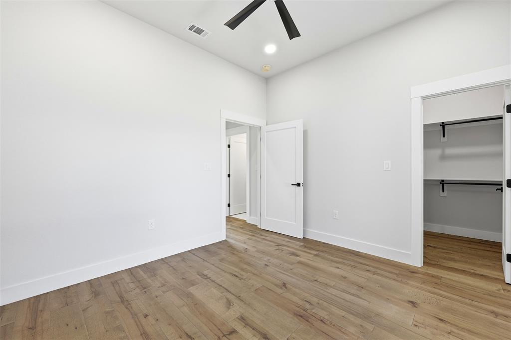 509 Emma Lane Grandview, TX 76050 - Photo 28 of 35 an empty room with wooden floor and ceiling fan