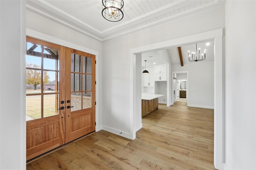 509 Emma Lane Grandview, TX 76050 - Photo 9 of 36 a view of an empty room with window and wooden floor