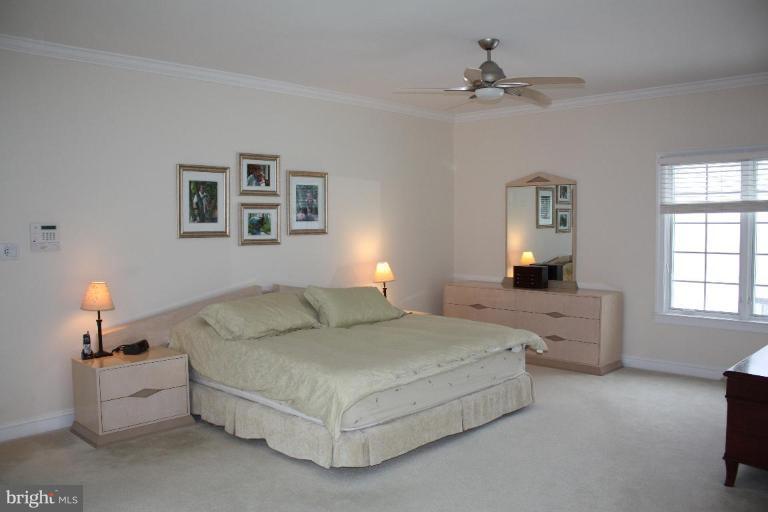 2124 Dixon Road Frederick, MD 21704 - Photo 13 of 30 a spacious bedroom with a bed and a chandelier