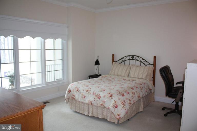 2124 Dixon Road Frederick, MD 21704 - Photo 17 of 30 a bedroom with a bed a table and windows