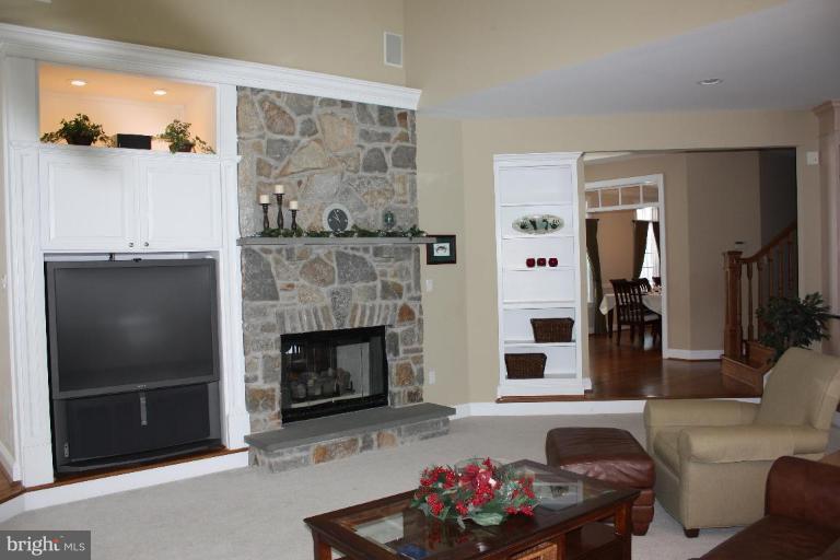 2124 Dixon Road Frederick, MD 21704 - Photo 20 of 30 a living room with furniture a flat screen tv and a fireplace