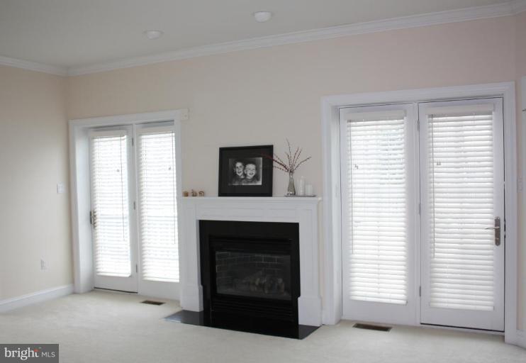2124 Dixon Road Frederick, MD 21704 - Photo 21 of 30 a living room with a fireplace and a window