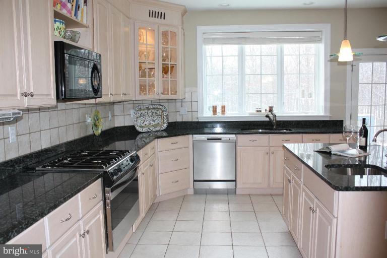 2124 Dixon Road Frederick, MD 21704 - Photo 10 of 30 a kitchen with granite countertop a sink stove top oven and cabinets