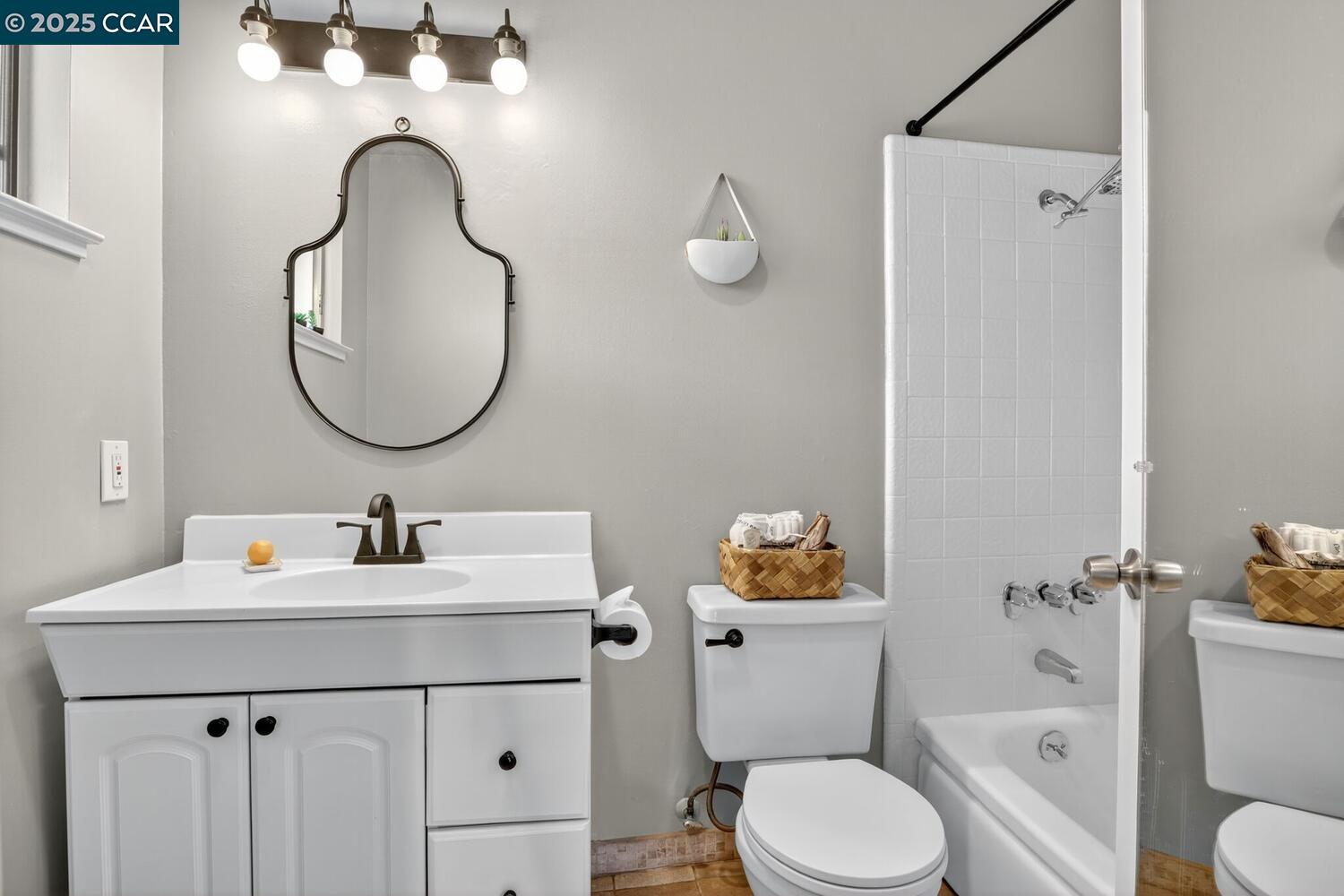 1601 Broadway, Unit 9 Alameda, CA 94501 - Photo 17 of 30 a bathroom with a sink a toilet and a mirror