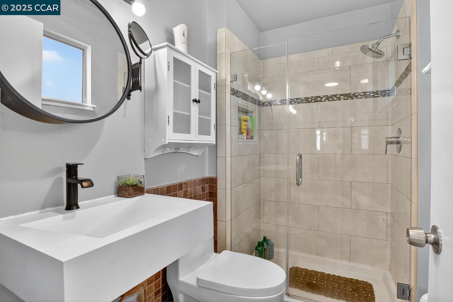 1601 Broadway, Unit 9 Alameda, CA 94501 - Photo 23 of 30 a bathroom with a sink a toilet and shower