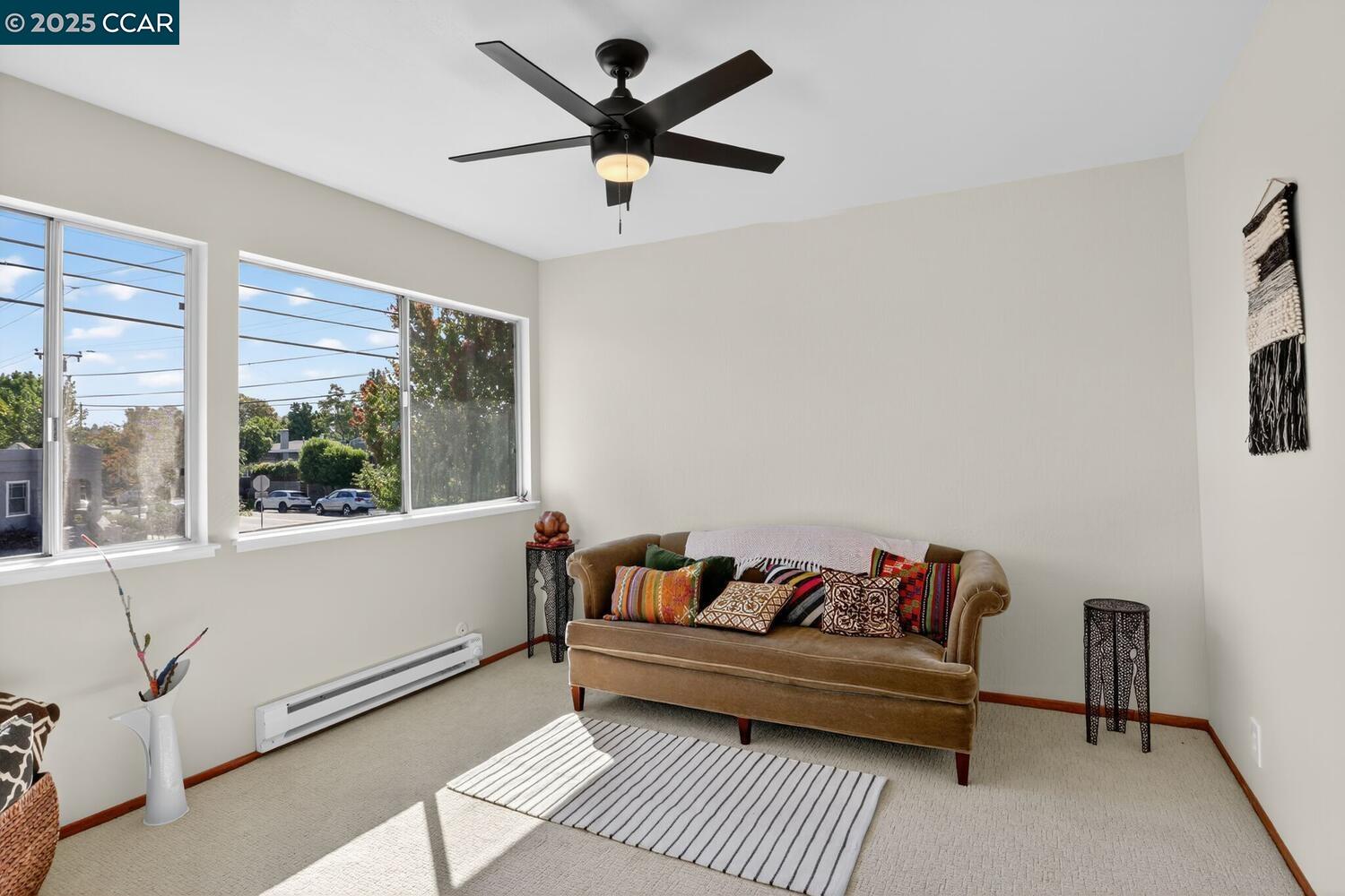 1601 Broadway, Unit 9 Alameda, CA 94501 - Photo 25 of 30 a white couch sitting in a living room next to a window