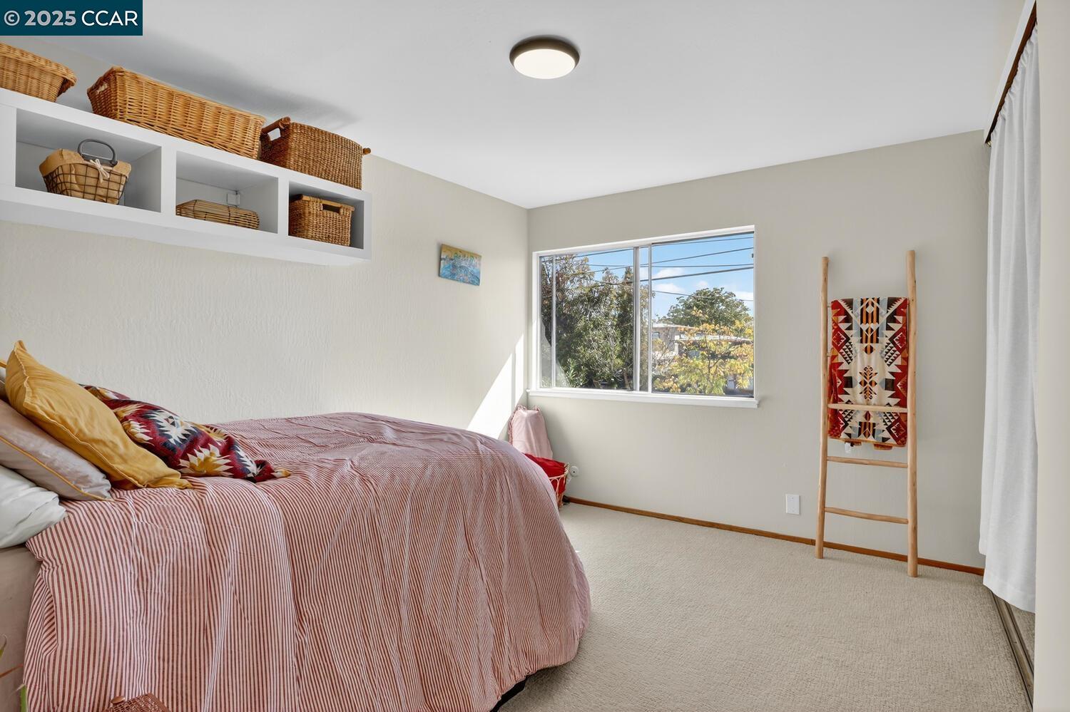 1601 Broadway, Unit 9 Alameda, CA 94501 - Photo 28 of 30 a bed sitting in a bedroom next to a window