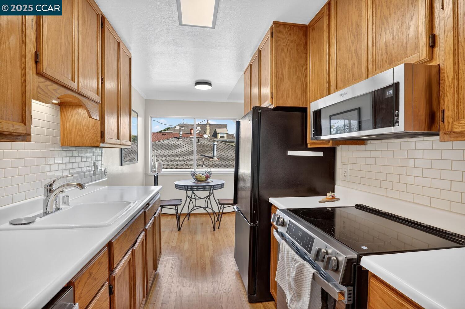 1601 Broadway, Unit 9 Alameda, CA 94501 - Photo 9 of 30 a kitchen with stainless steel appliances a stove a sink dishwasher and cabinets