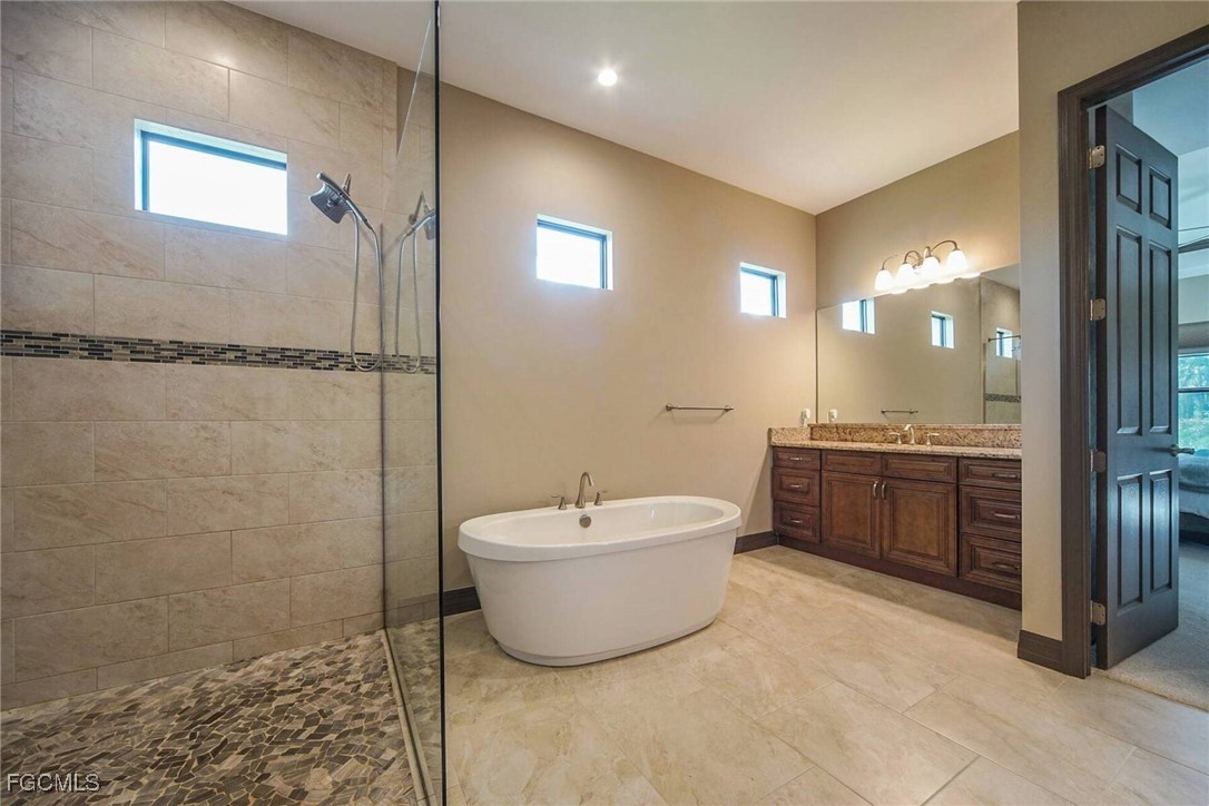 6142 Calusa Rdg Trail Bokeelia, FL 33922 - Photo 14 of 43 a bathroom with a bathtub and shower