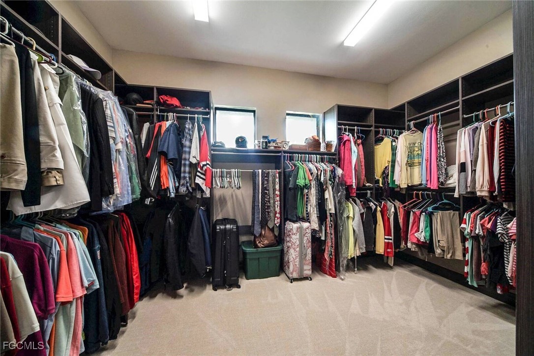 6142 Calusa Rdg Trail Bokeelia, FL 33922 - Photo 16 of 43 a view of walk in closet with clothes