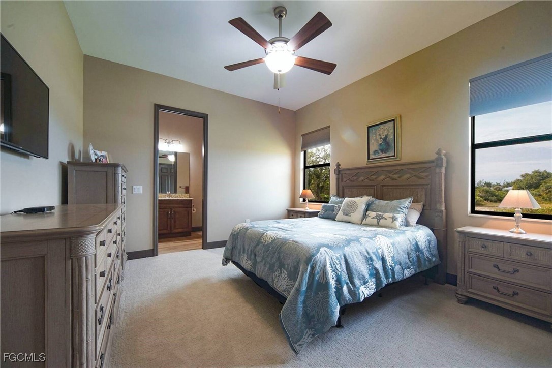 6142 Calusa Rdg Trail Bokeelia, FL 33922 - Photo 19 of 43 a bedroom with a bed and a flat screen tv