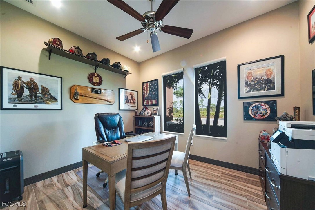 6142 Calusa Rdg Trail Bokeelia, FL 33922 - Photo 21 of 43 a view of a dining room with furniture a chandelier and wooden floor