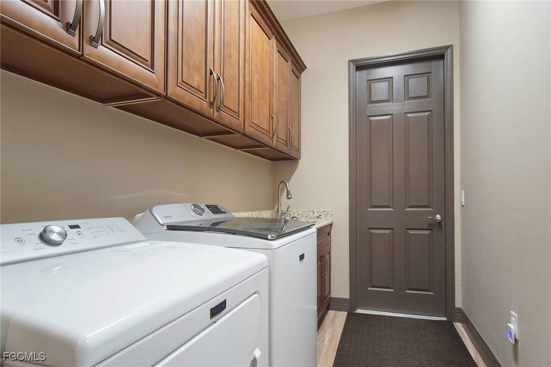 6142 Calusa Rdg Trail Bokeelia, FL 33922 - Photo 22 of 43 a utility room with dryer and washer