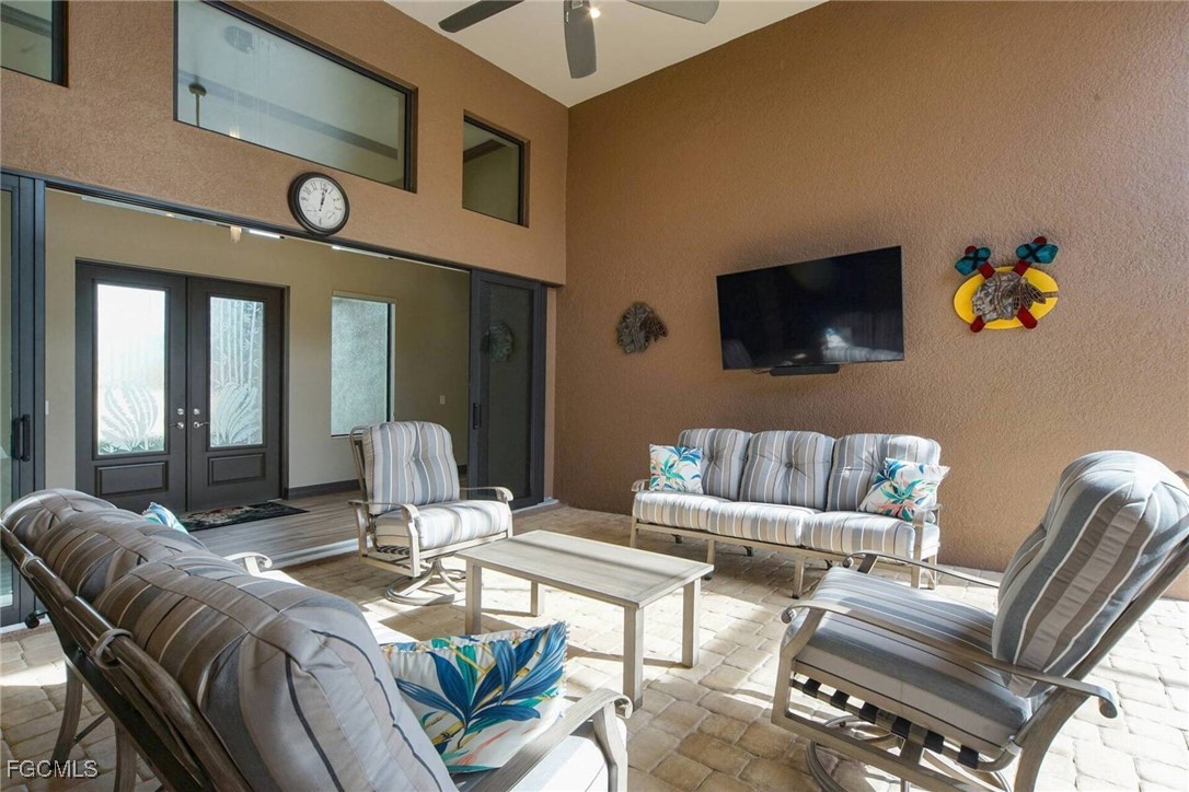 6142 Calusa Rdg Trail Bokeelia, FL 33922 - Photo 26 of 43 a living room with furniture a flat screen tv and kitchen view