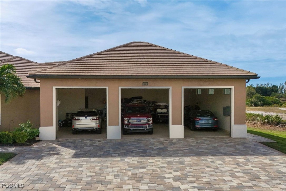 6142 Calusa Rdg Trail Bokeelia, FL 33922 - Photo 28 of 43 a view of a car in front of a house