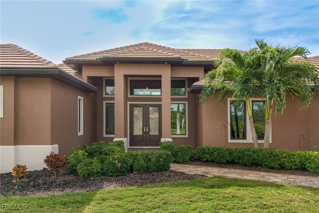 6142 Calusa Rdg Trail Bokeelia, FL 33922 - Photo 3 of 43 a front view of a house with garden