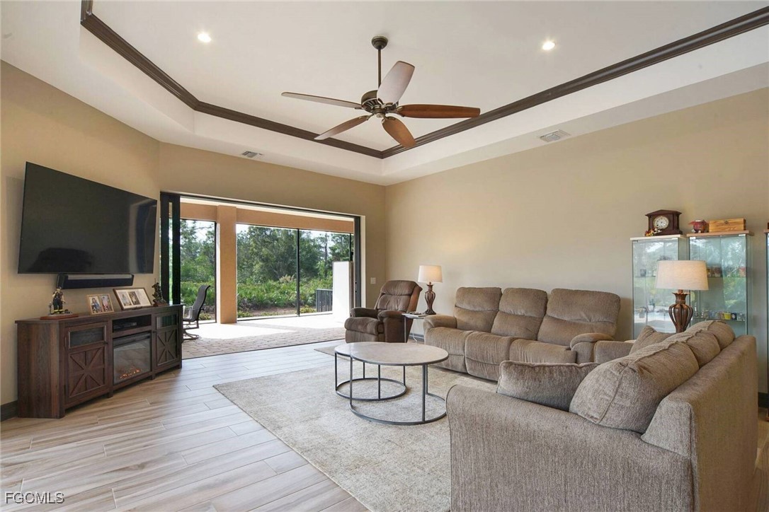 6142 Calusa Rdg Trail Bokeelia, FL 33922 - Photo 5 of 43 a living room with furniture a flat screen tv and a large window