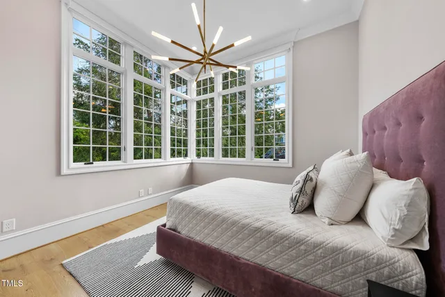 a bedroom with a large bed and a large window