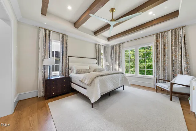 a living room with fireplace furniture and a large window
