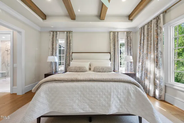a living room with furniture fireplace and large windows
