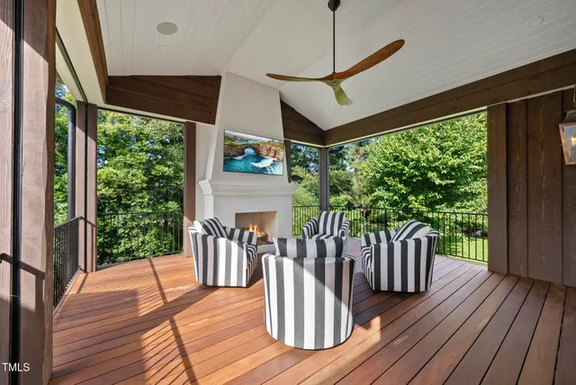 a living room with furniture a fireplace and a floor to ceiling window