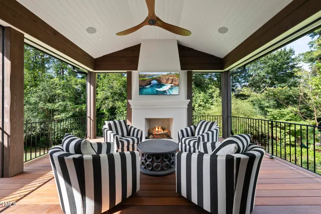a view of a big house with a big yard and large trees