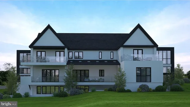 a front view of residential houses with yard and green space