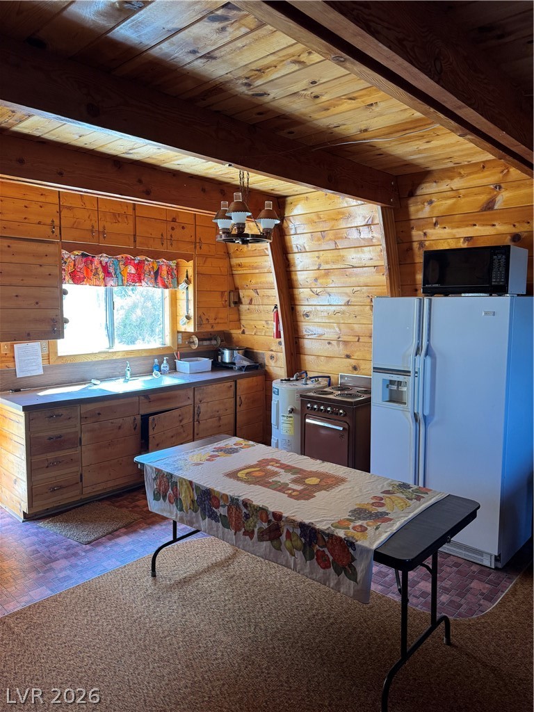 20996 Pinion Pine Road Pioche, NV 89043 - Photo 3 of 19 This cozy kitchen features rustic wood paneling and convenient appliances for comfortable living.