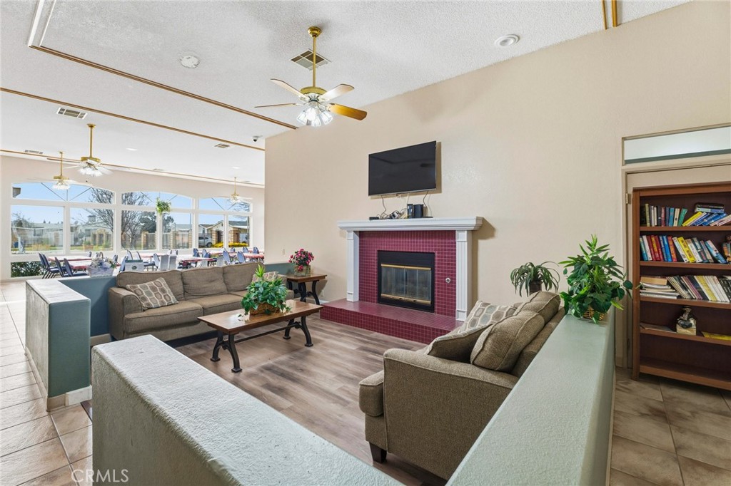 20683 Waalew Road, Unit B201 Apple Valley, CA 92307 - Photo 30 of 32 a living room with furniture a fireplace and a flat screen tv