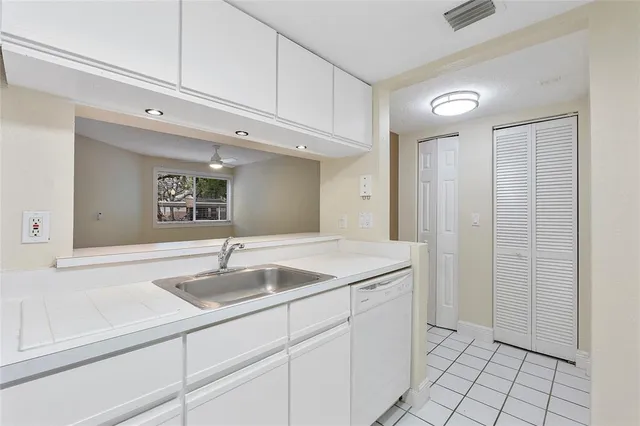 a kitchen with a sink and cabinets