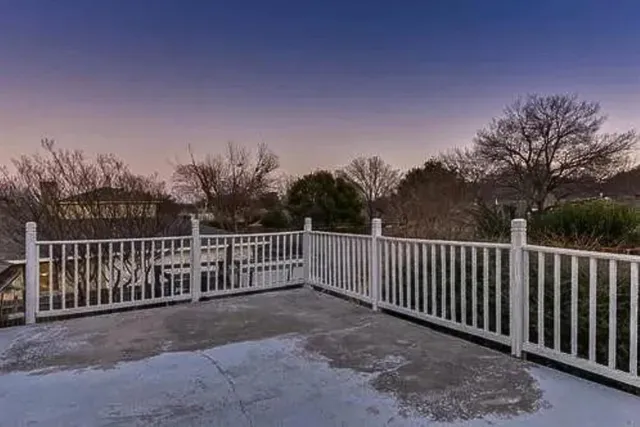 a view of backyard with a small cabin and a chair