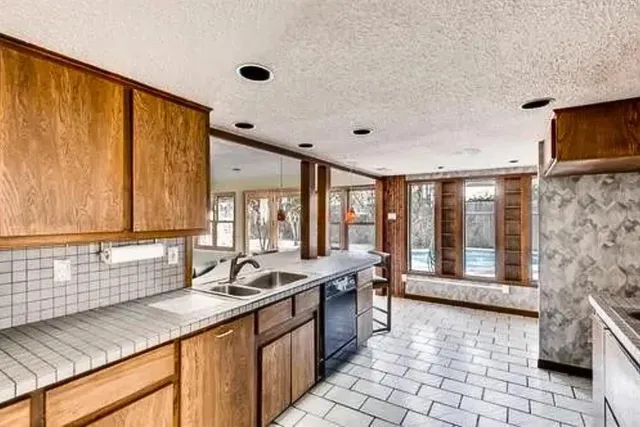 a kitchen with stainless steel appliances a sink stove and cabinets