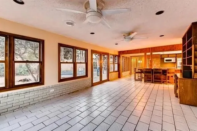 a living room with furniture and large windows
