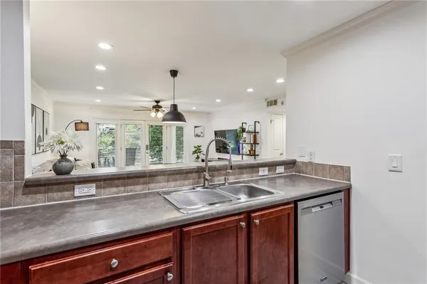 a kitchen with a sink and a mirror