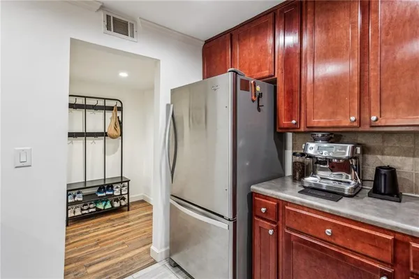 a kitchen with metallic refrigerator and cabinets
