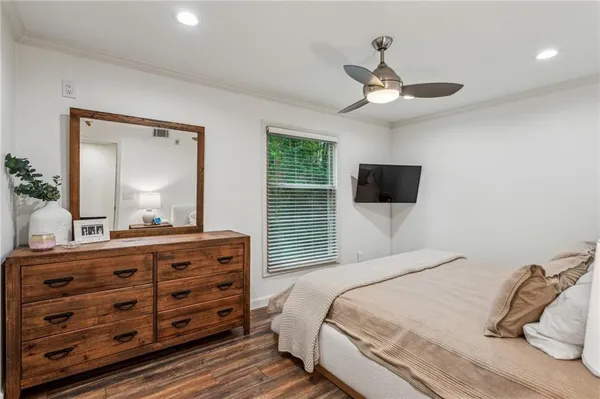 a bedroom with a bed and a dresser