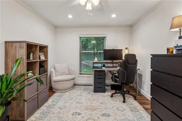 a view of a workspace with furniture and a potted plant